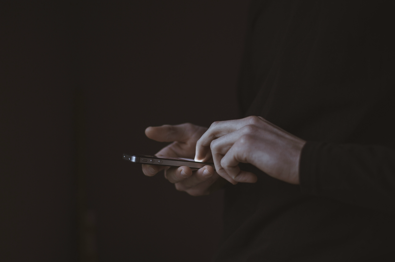 Photo of torso and hands using a phone